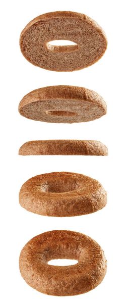Halved bagel tops levitating in different positions isolated on white background - Photo, Image