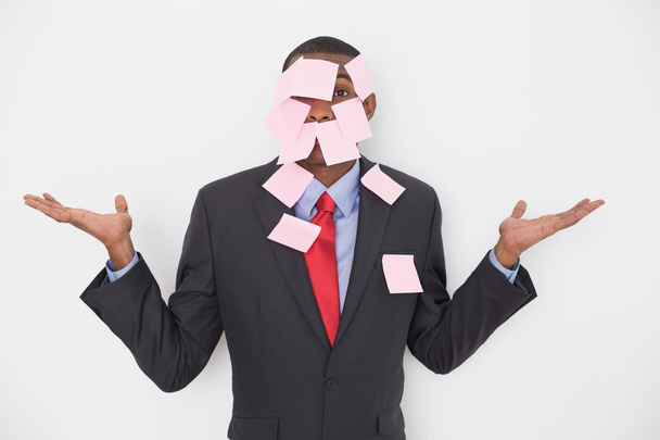 Portrait of an Afro businessman covered in blank notes - Fotoğraf, Görsel