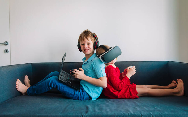 niños jugando videojuegos en casa, niño y niña con controles remotos en el interior
 - Foto, imagen