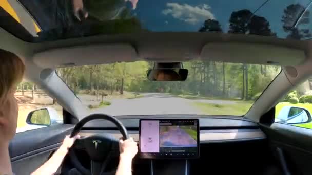 Person driving a new Tesla Model 3 - Felvétel, videó