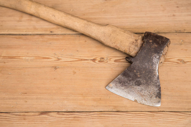Old ax with a wooden handle stuck in wooden log. Concept for woodworking or deforestation. Selective focus. - 写真・画像