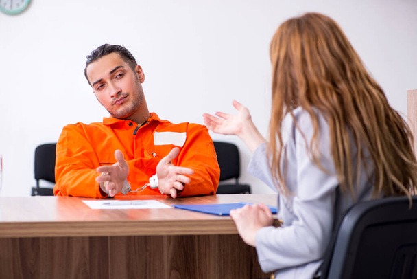 Young man meeting with advocate in pre-trial detention - 写真・画像