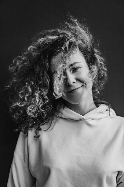 young woman with curly hair. portrait close-up. - Fotó, kép