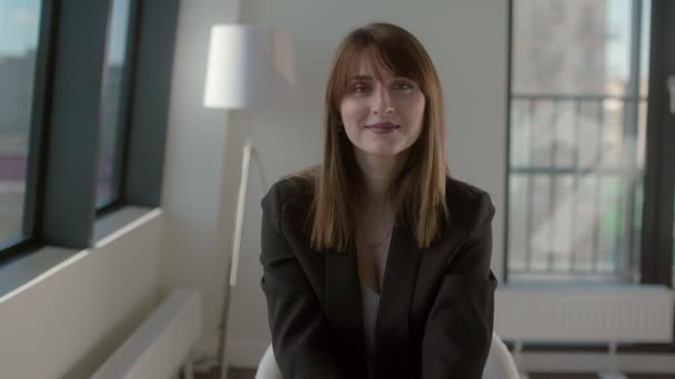 Portrait of a beautiful good looking woman in a business suit - Materiał filmowy, wideo