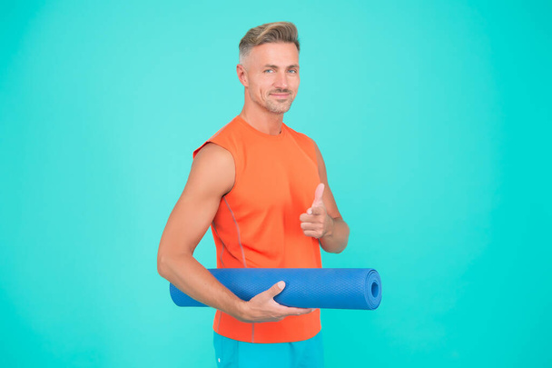 Are you with me. Sportsman point finger blue background. Sports coach hold yoga mat. Physical training and sports. Sports gym or club. Yoga and pilates. Sport and fitness. Sports activities for you - 写真・画像