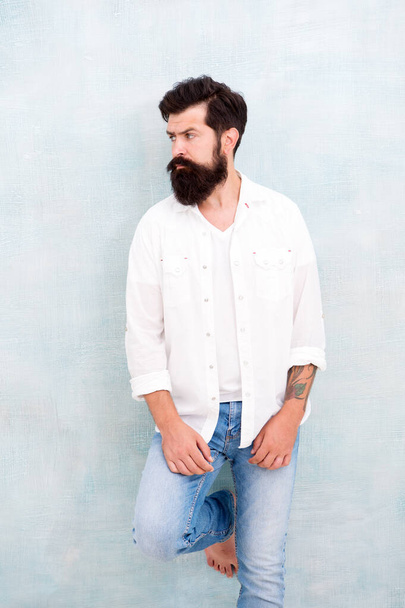 Fashion clothes. Attractive guy wall background. Summer fashion. Bearded model casual outfit. Fashion model. Mature handsome hipster with beard wear white shirt. Summer collection. Menswear concept - Фото, изображение