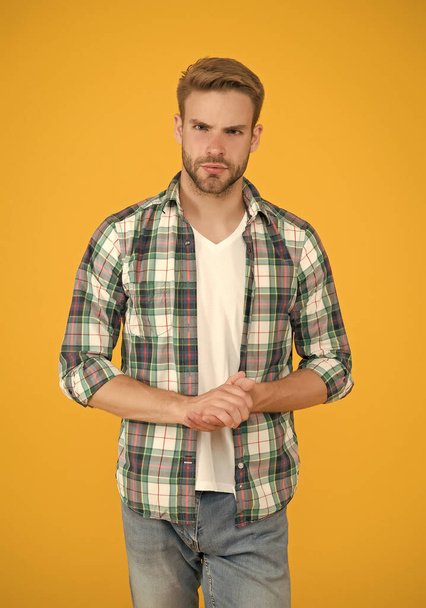 stylish male in trendy clothing. handsome man in checkered shirt and jeans. charismatic student yellow background. Make You Look Good. casual fashion for men. Masculine Outfits And Look - Fotoğraf, Görsel