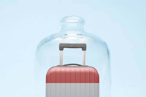 Suitcase with Indonesian flag design in quarantine minimal creative coronavirus travel restriction concept. - Foto, Imagem