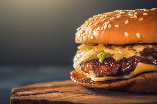 Fresh delicious homemade burger or hamburger with juicy meat, cheese and vegetables, fast food, macro photo, copy space - Photo, image