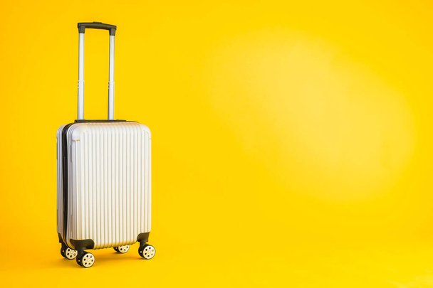 Gray color luggage or baggage bag use for transportation travel and leisure on yellow isolated background - Φωτογραφία, εικόνα
