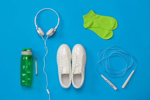 A set of fitness accessories on a blue background. - Фото, зображення