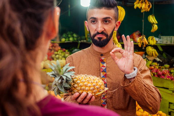 arabian man offering a pineapple on the street in goa - Photo, image