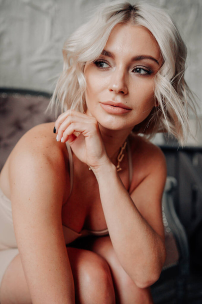 blonde beautiful young woman in stylish clothes posing in loft interior   - Valokuva, kuva