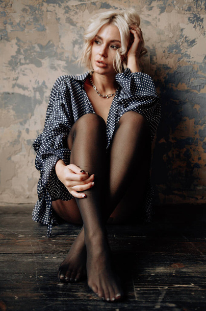 blonde beautiful young woman in stylish clothes posing in loft interior   - Φωτογραφία, εικόνα