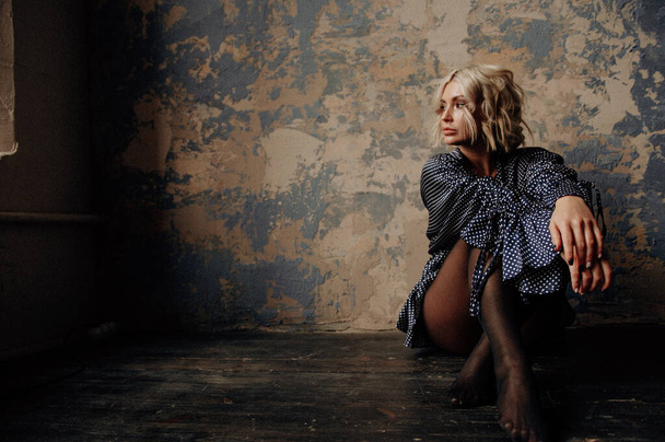 blonde beautiful young woman in stylish clothes posing in loft interior   - Φωτογραφία, εικόνα