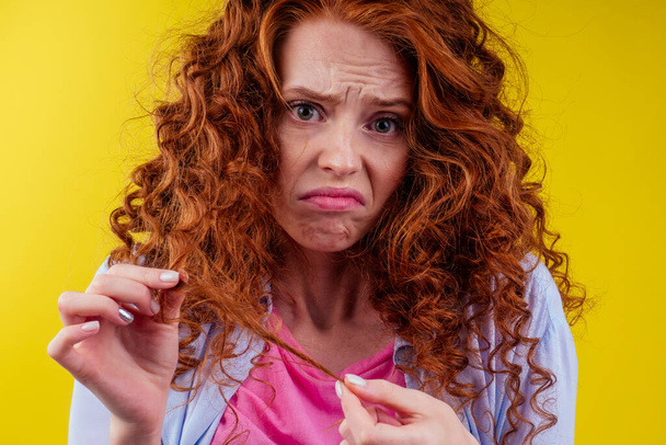 upset redhaired ginger foxy woman with dryness tangled red hair - Foto, imagen