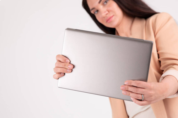 Successful business woman on grey background with copy space laptop mock up, blank - Photo, Image