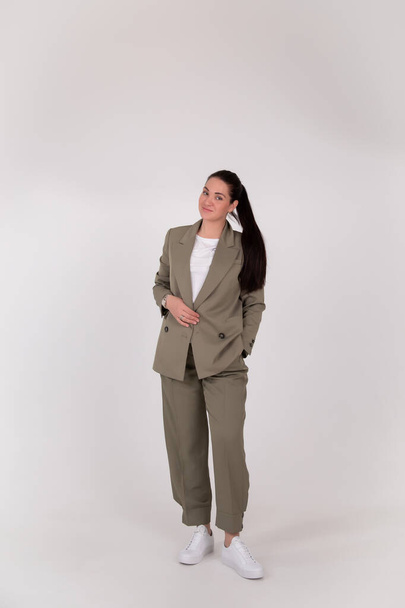 Successful business woman on grey background with copy space. Director in suit - Фото, изображение