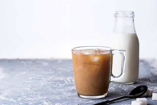 Fragrant custard with milk, spoon, sugar, concrete background. Coffee drink with milk. - Foto, afbeelding