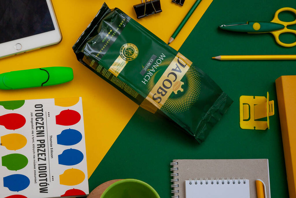 Kyiv, Ukraine - April 16, 2020: Jacobs coffee on the desktop. Coffee packing. Workspace. Layout. Stationery on a bright yellow and green background. Work remotely and drink coffee. - Zdjęcie, obraz