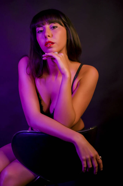 beautiful brunette girl with long hair in underwear sitting in color photo - Fotoğraf, Görsel