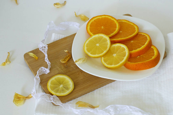 Food composition with lace, orange and lemons - Φωτογραφία, εικόνα