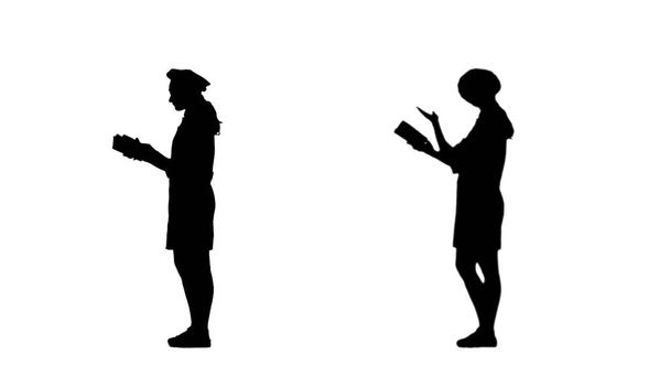 Δύο μαύρες σιλουέτες του σεφ που διαβάζει ένα βιβλίο με συνταγές. - Φωτογραφία, εικόνα