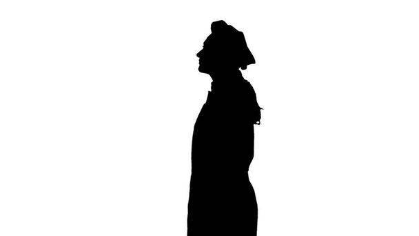 La silueta negra de la cocinera en un toque y delantal está de pie aislada sobre un fondo blanco. Retrato de perfil
 - Foto, Imagen