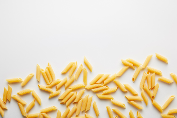 Top view of uncooked pasta on white background  - Zdjęcie, obraz