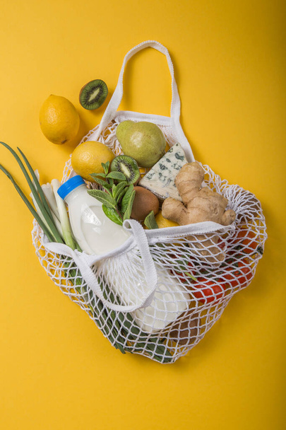 Zero waste concept. Colorful lifestyle. No Plastic free items. Reuse, reduce, refuse. Package-free food shopping. Eco friendly natural bag with organic fruits and vegetables. Top view. - 写真・画像