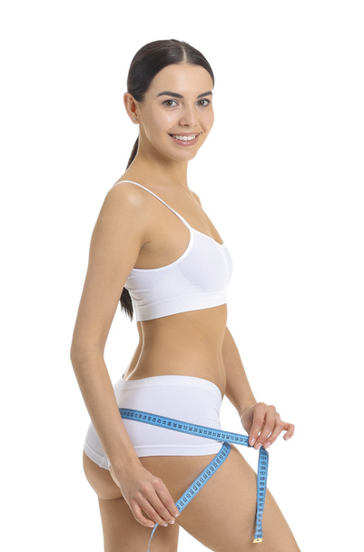 Young woman with measuring tape on white background. Weight loss concept - Foto, afbeelding