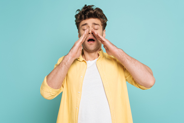 Front view of man sneezing isolated on blue - Photo, Image