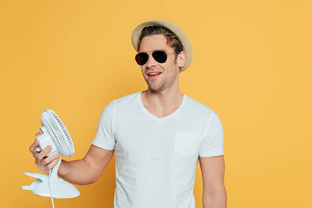 Front view of man in hat and sunglasses holding  - Fotoğraf, Görsel