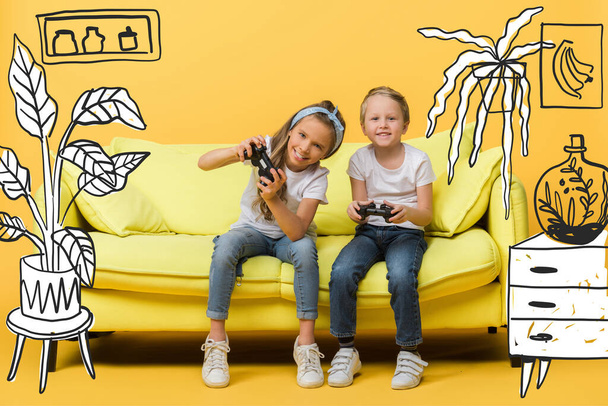 KYIV, UKRAINE - MARCH 4, 2020: happy siblings playing video game with joysticks on sofa on yellow, interior illustration - Foto, afbeelding