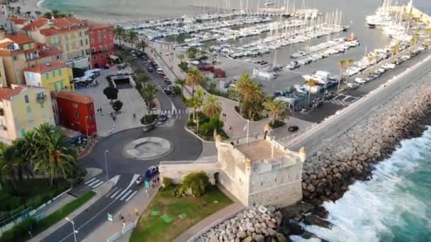 Flight of the drone over the sea, the fortress and the seaport with yachts. Menton, France. Aerial View - Footage, Video