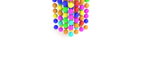 Bolas de goma de colores caen sobre una superficie blanca
 - Metraje, vídeo