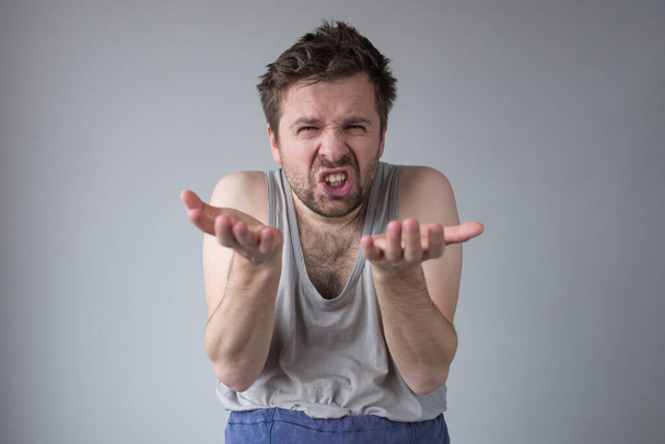 man standing with raised fists and clenched teeth, experiencing strong aggression - Photo, Image
