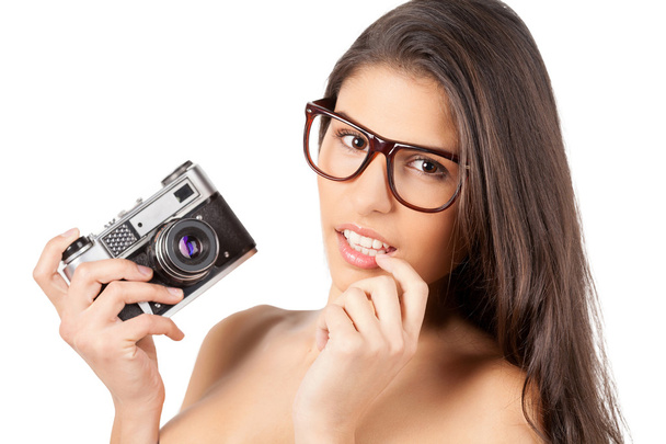 Young shirtless woman holding camera - 写真・画像