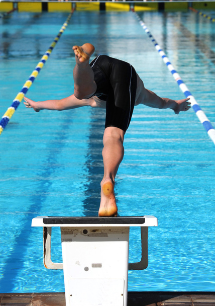 Swimmer dives into the water of a pool. - Photo, Image