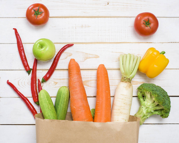  vegetables in grocery bag on white wood background - Valokuva, kuva