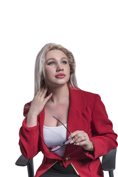Beautiful young girl, blonde, business woman in a red jacket and suit with glasses on a white isolation background. - Photo, Image