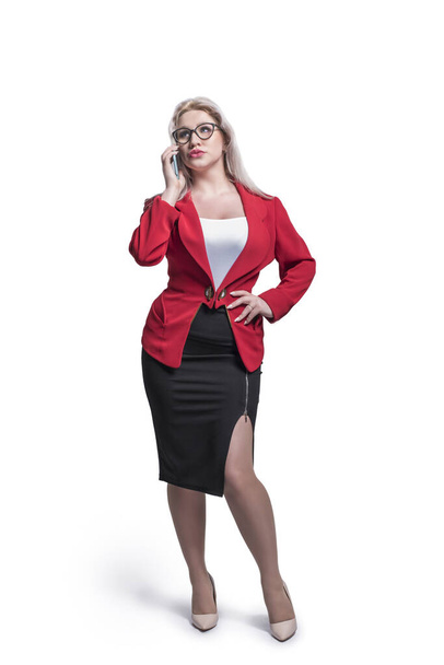 Beautiful young girl, blonde, business woman in a red jacket and suit, with glasses on a white isolation background. - Photo, image