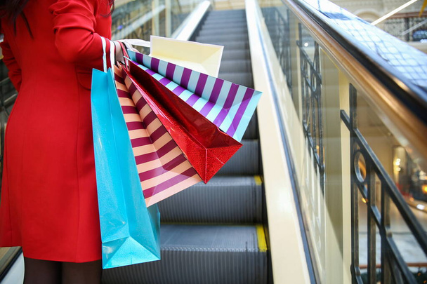female with shopping bags in the mall close up without face - 写真・画像