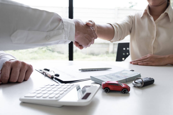 Sprzedawca samochodów i klient uścisk dłoni po zakończeniu podpisał umowę wynajmu samochodu w biurze, Koncepcja wynajmu samochodów. - Zdjęcie, obraz