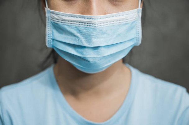 Close up young asian woman wearing protection face mask against coronavirus. - Photo, Image