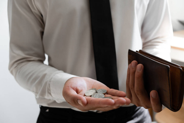 Businessman holding money and brown wallet in hands, reserve money concept. - Foto, Imagem