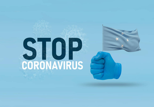 COVID-19視覚コンセプト- hand-textストップコロナウイルス、手ジェスチャー対ウイルス感染、握りこぶしはミクロネシア連邦の旗を保持しています。流行の3Dイラスト. - 写真・画像