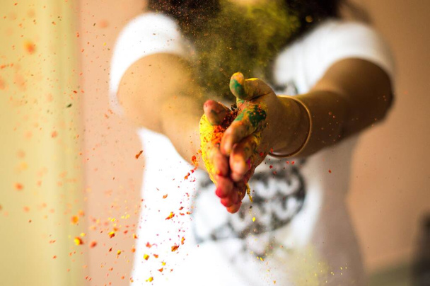 A closeup shot of a female blowing the colorful party smoke - Foto, Imagem