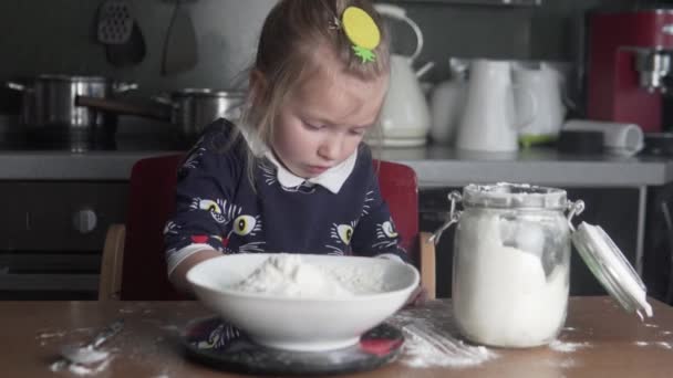 A little girl cooks. - Video