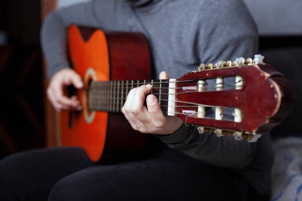 girl playing a six string acoustic guitar with nylon strings - Foto, Imagen